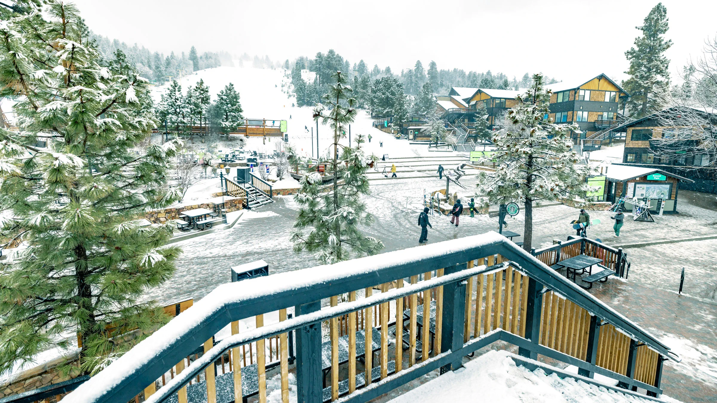 Stairway overlooking the base area at Snow Summit with new snow on the ground and walkways